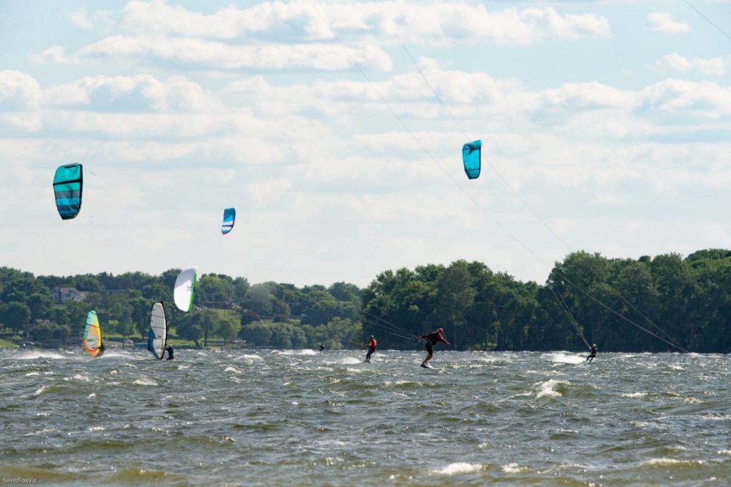 Kiteboarders and windsurfers on a windy lake